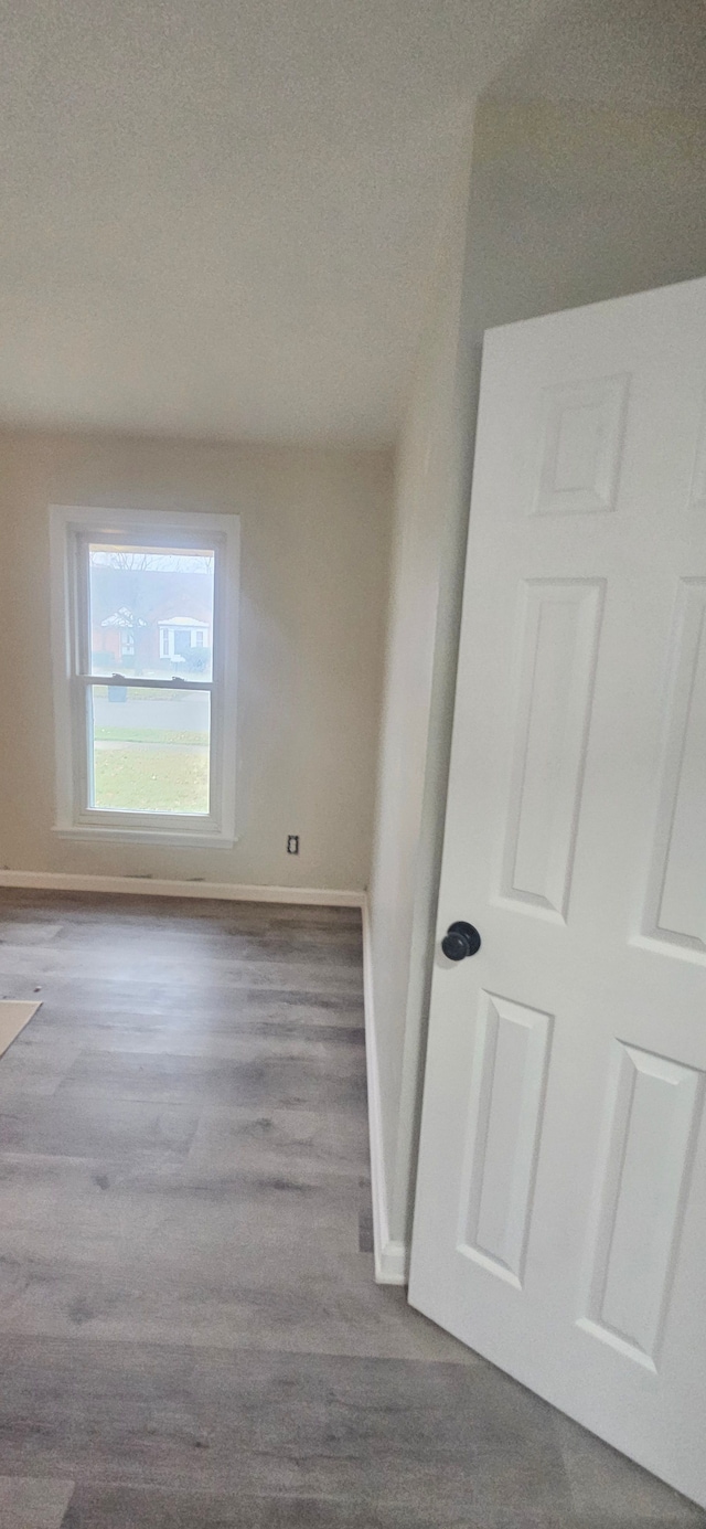 empty room with light wood-type flooring and a textured ceiling