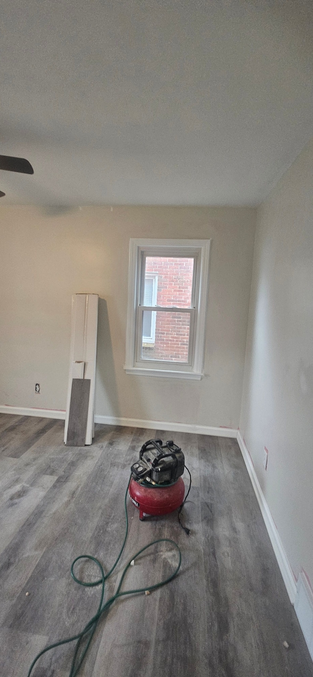 empty room featuring ceiling fan, wood-type flooring, and a textured ceiling