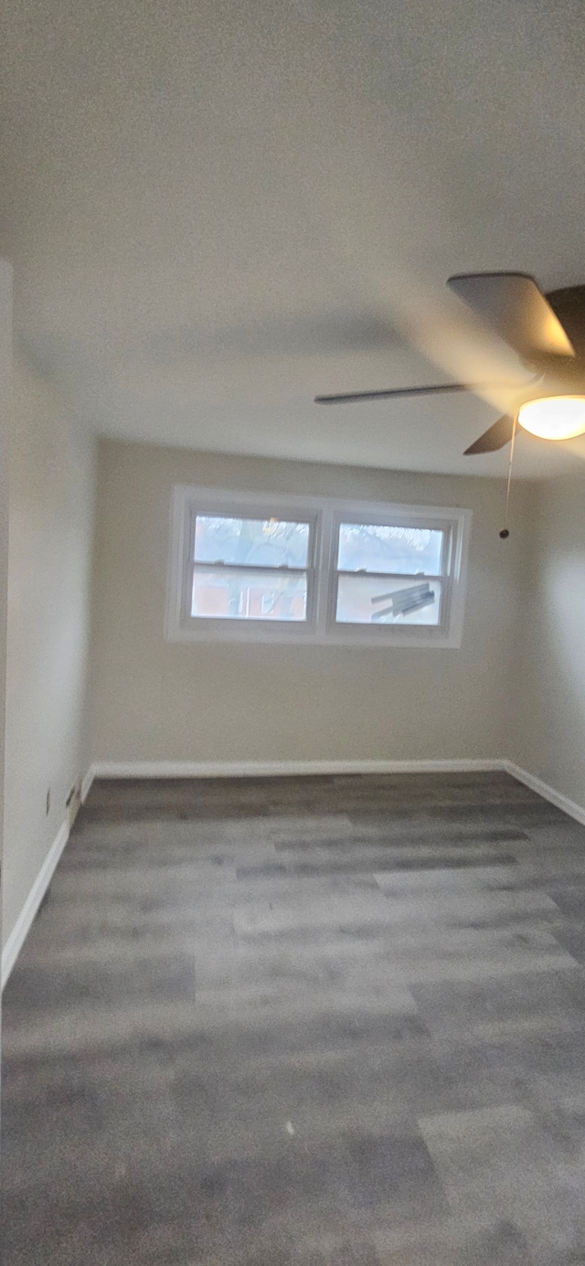 spare room featuring ceiling fan, a textured ceiling, and dark colored carpet