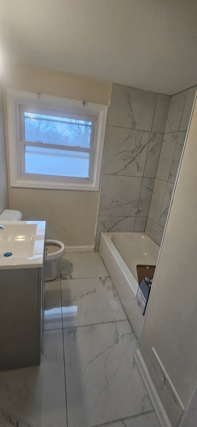 bathroom with vanity, toilet, and a wealth of natural light