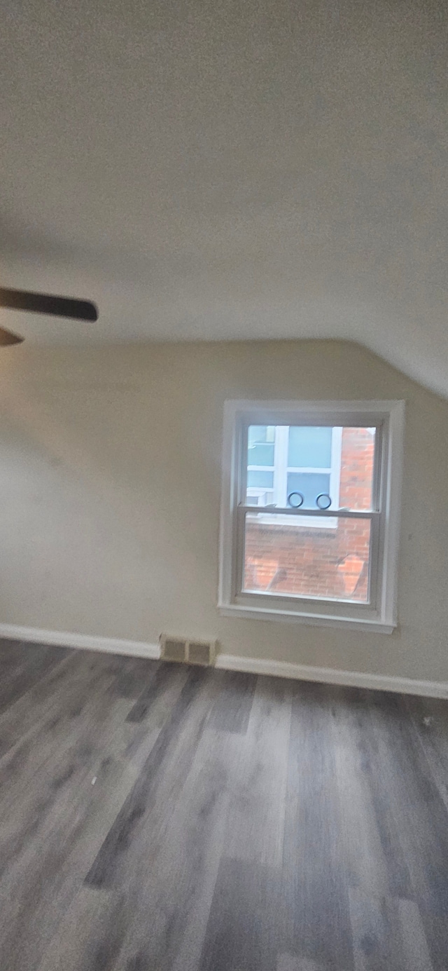 interior space with hardwood / wood-style floors, lofted ceiling, and a textured ceiling