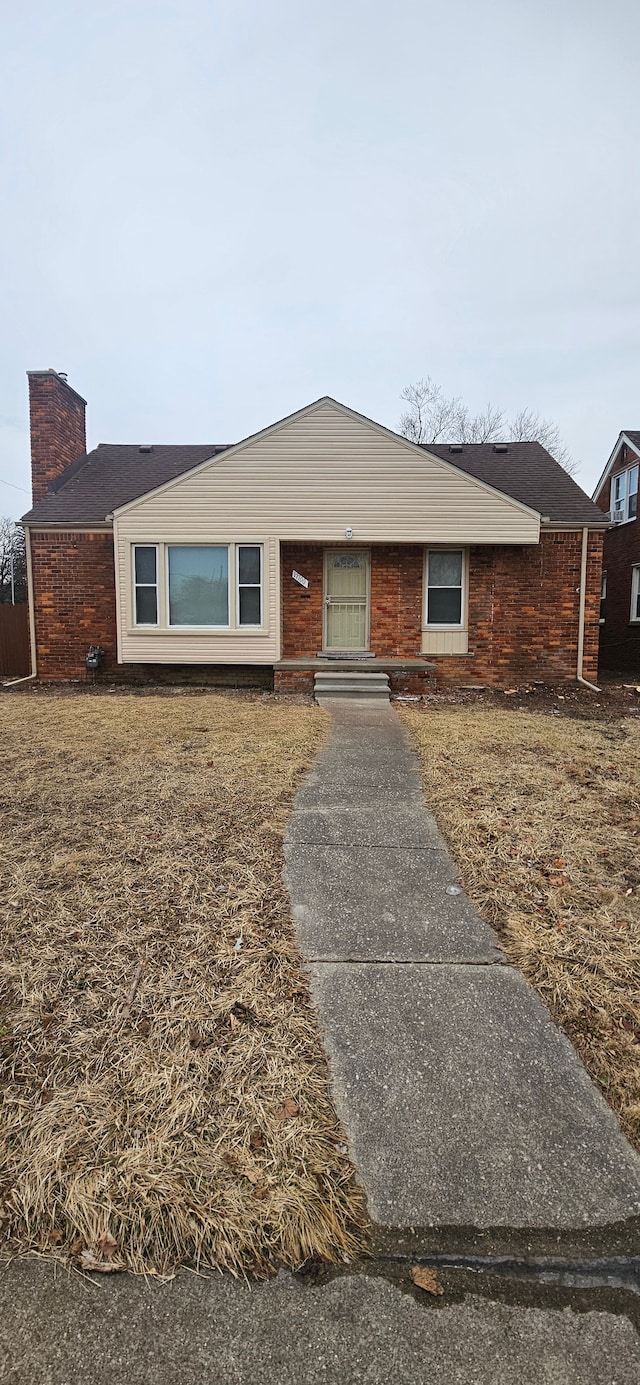 single story home featuring a chimney