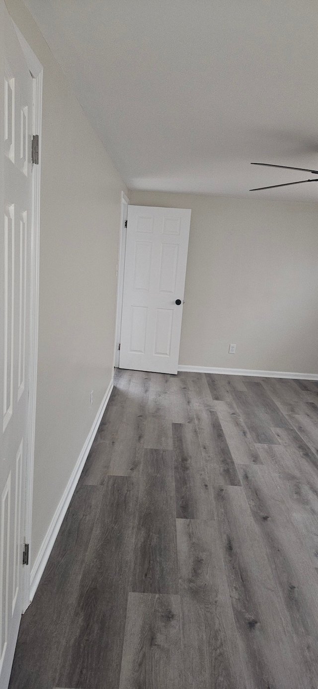 spare room with wood finished floors and baseboards