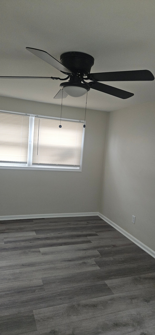 unfurnished room featuring a ceiling fan, baseboards, and wood finished floors