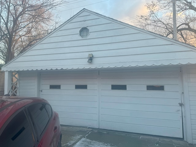 view of garage at dusk