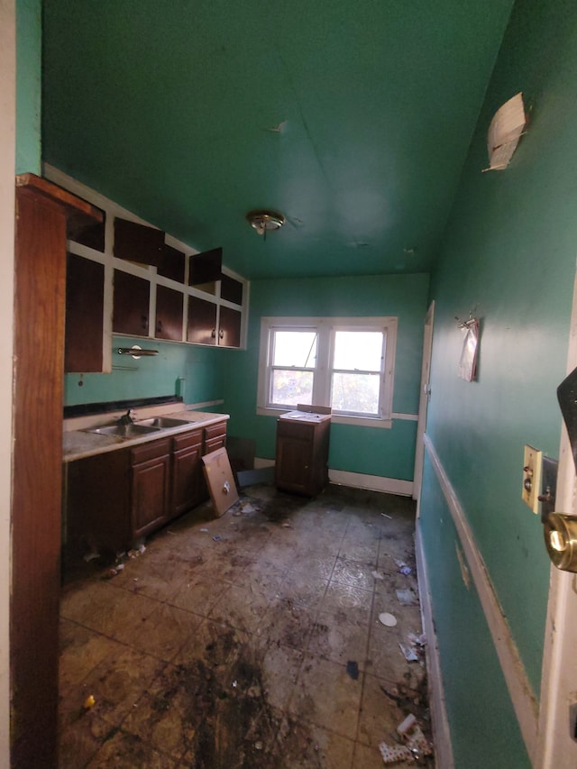 kitchen with dark brown cabinetry and sink