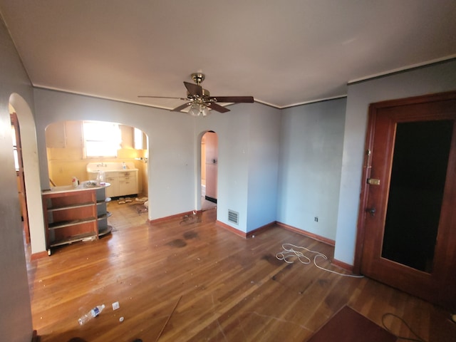 interior space with wood-type flooring and ceiling fan