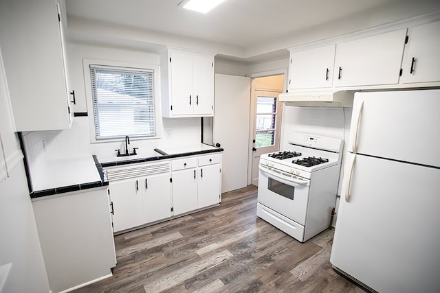 kitchen featuring white cabinetry, white appliances, and wood-type flooring