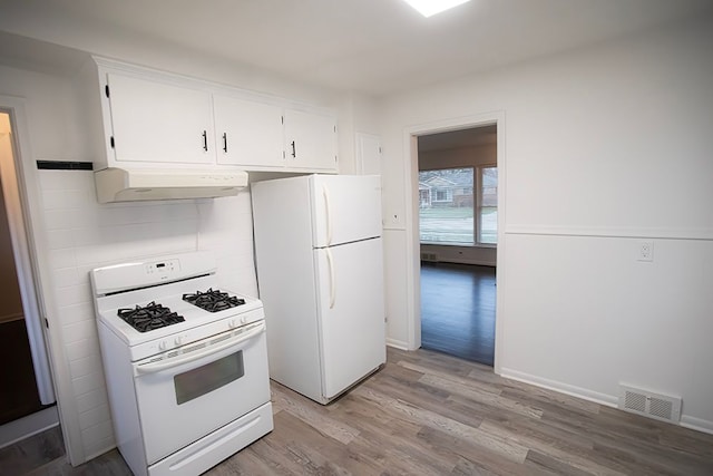 kitchen with white cabinets, light wood-type flooring, and white appliances