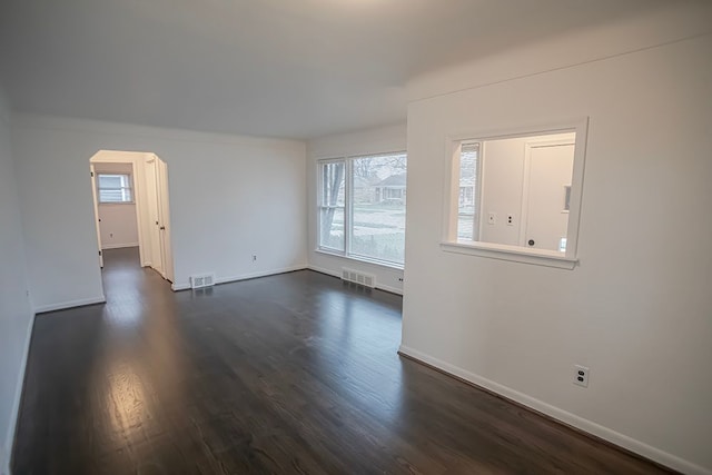 unfurnished living room featuring dark hardwood / wood-style flooring