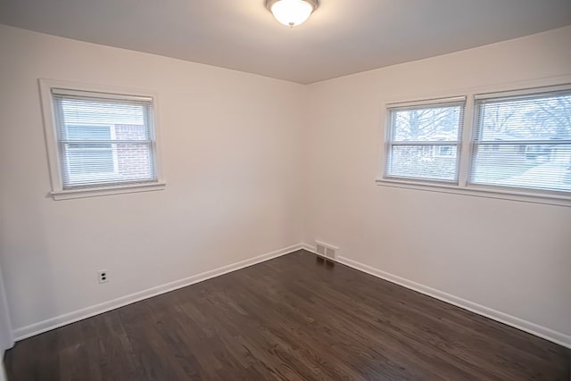 spare room featuring dark wood-type flooring