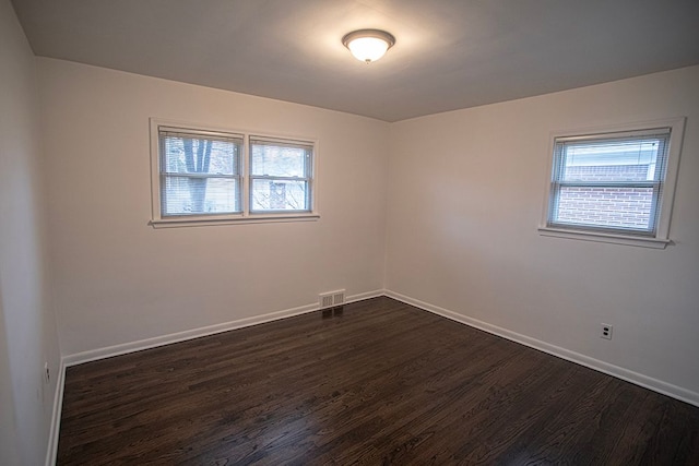 empty room featuring dark hardwood / wood-style flooring