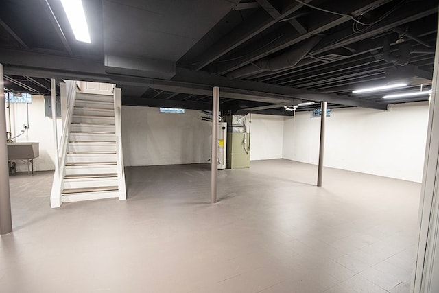 basement featuring gas water heater and sink