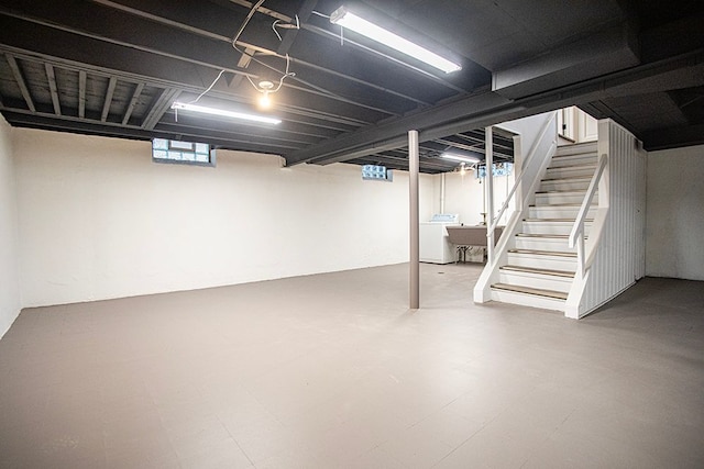 basement with tile patterned floors, washer / clothes dryer, and stairs