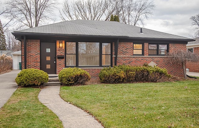 view of front of property featuring a garage and a front lawn