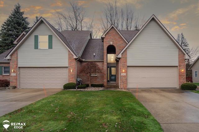 view of front facade featuring a lawn and a garage