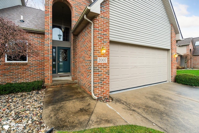 doorway to property with a garage