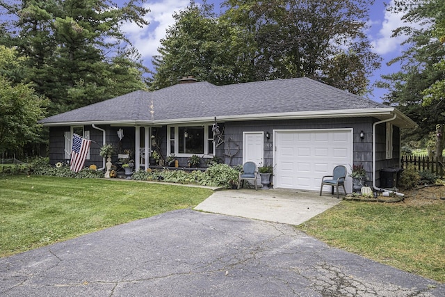 single story home with a garage and a front lawn