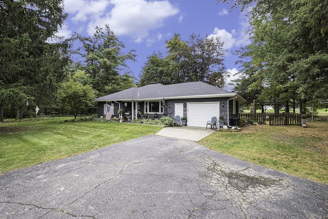 single story home featuring a garage and a front lawn