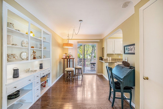 dining area with dark hardwood / wood-style floors