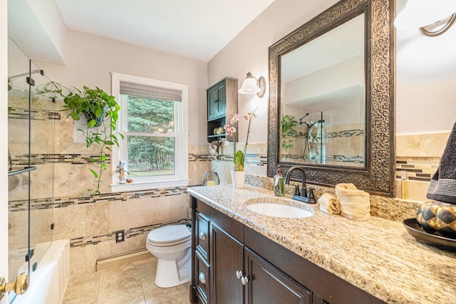 bathroom with tile patterned flooring, vanity, tile walls, and toilet