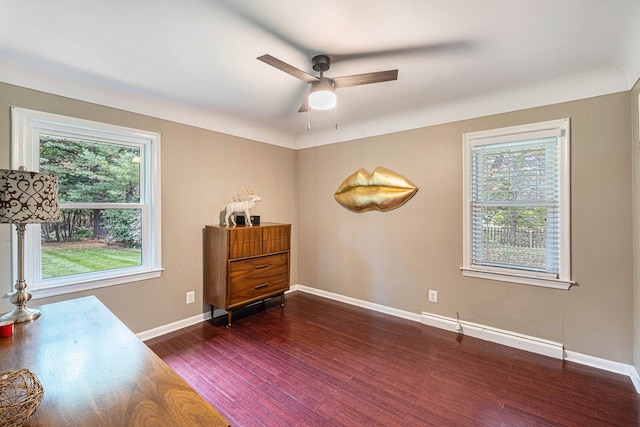 interior space with ceiling fan and dark hardwood / wood-style flooring