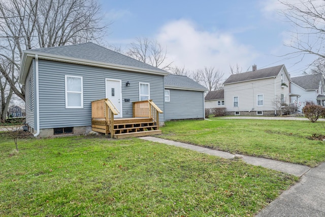308 N Elm St, Three Oaks, MI 49128 - back of house with a lawn and a shingled roof