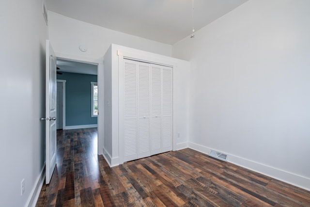 308 N Elm St, Three Oaks, MI 49128 - unfurnished bedroom with dark wood-type flooring and a closet
