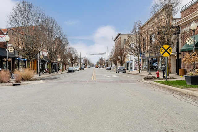 308 N Elm St, Three Oaks, MI 49128 - view of asphalt road featuring curbs, sidewalks, traffic signs, and a residential view