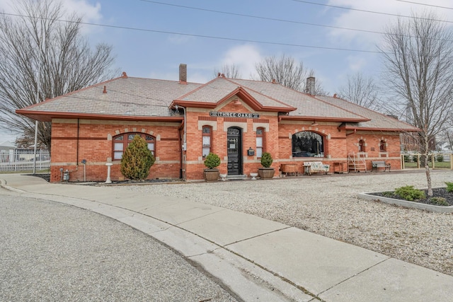 308 N Elm St, Three Oaks, MI 49128 - view of front facade with brick siding and a chimney