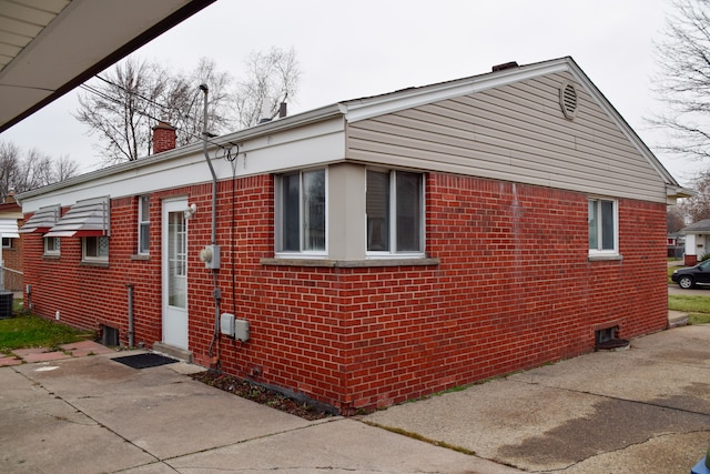 view of side of property featuring central air condition unit