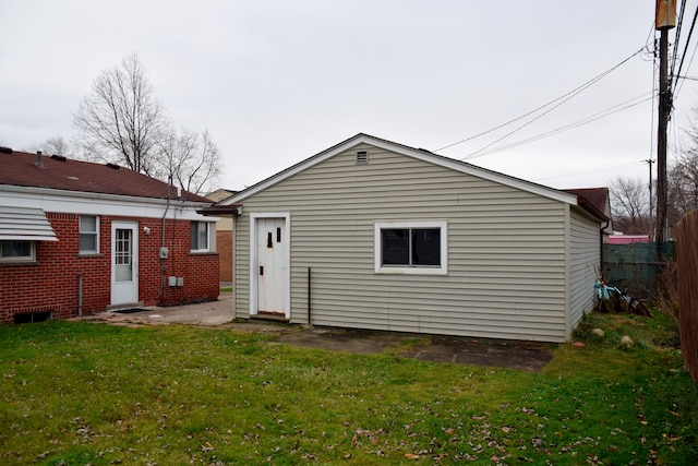 rear view of property with a lawn