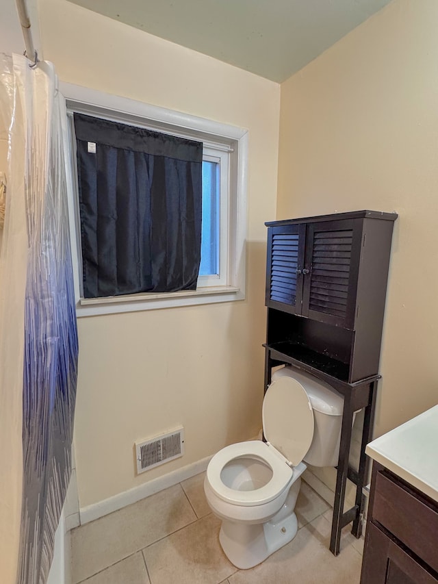 bathroom with vanity, toilet, and tile patterned flooring