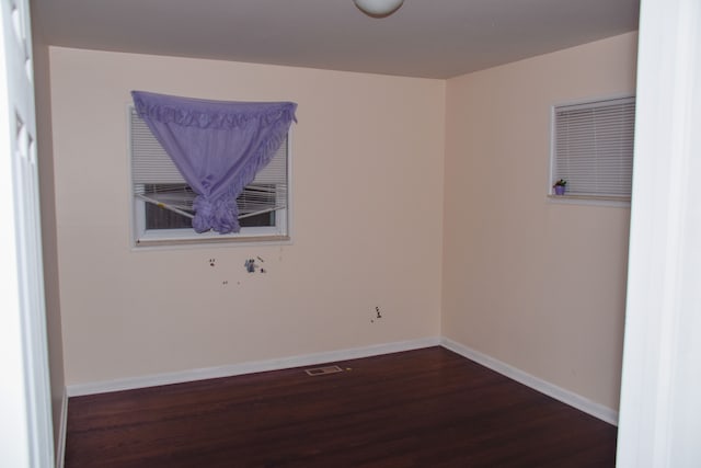 spare room featuring dark hardwood / wood-style flooring