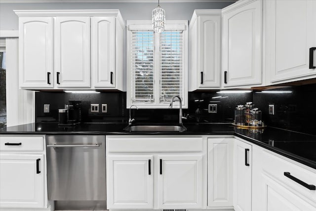 kitchen featuring sink, hanging light fixtures, stainless steel dishwasher, a notable chandelier, and white cabinets