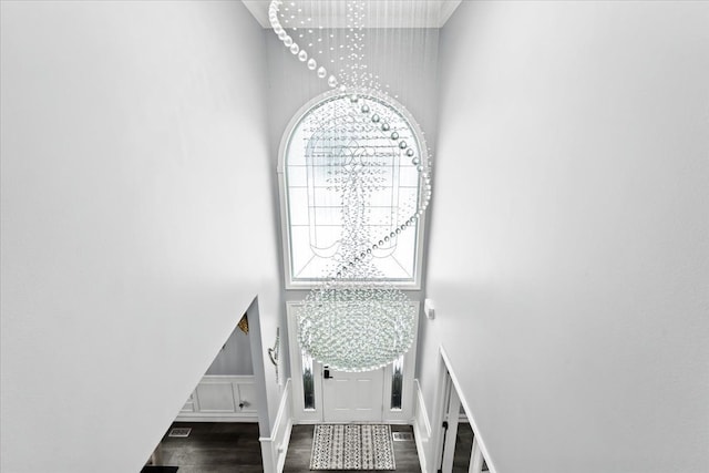 stairway with a towering ceiling and hardwood / wood-style flooring