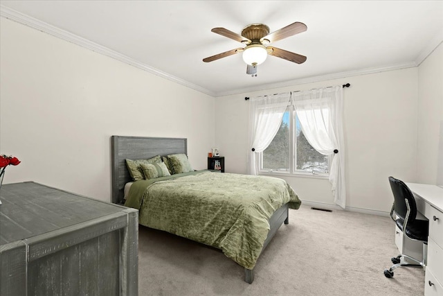 carpeted bedroom with ceiling fan and crown molding