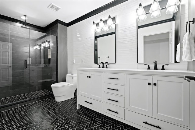 bathroom with vanity, toilet, a shower with shower door, and crown molding