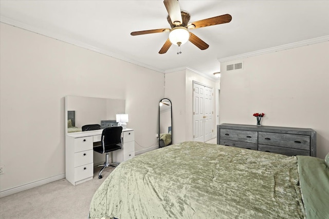 bedroom featuring ceiling fan, crown molding, light carpet, and a closet