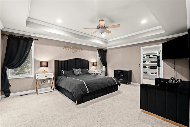 carpeted bedroom featuring a raised ceiling, ceiling fan, and crown molding