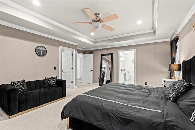 carpeted bedroom with connected bathroom, a raised ceiling, ceiling fan, and ornamental molding