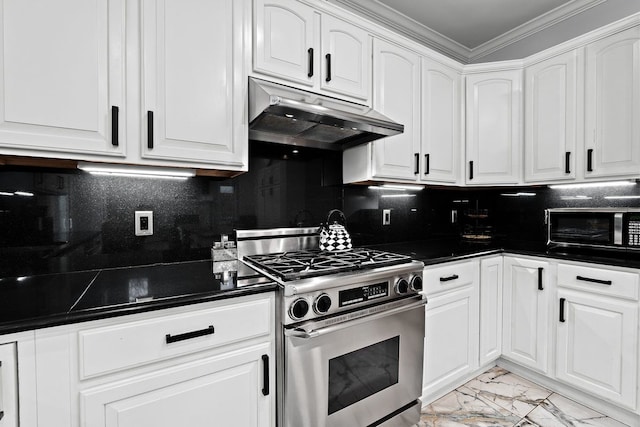 kitchen with white cabinets, gas stove, crown molding, and backsplash