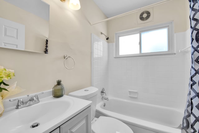 full bathroom with vanity, shower / tub combo, and toilet