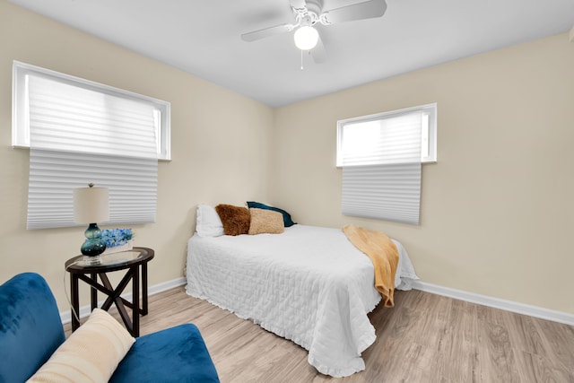 bedroom with ceiling fan and light wood-type flooring