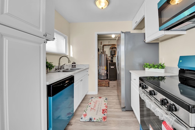 kitchen with sink, gas water heater, light hardwood / wood-style flooring, white cabinets, and appliances with stainless steel finishes