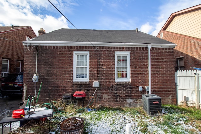 back of house featuring cooling unit