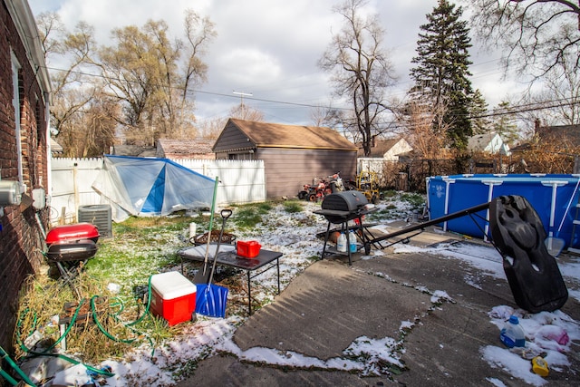 view of yard featuring a fenced in pool and central air condition unit