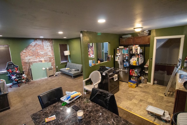 interior space with stainless steel fridge, dark stone countertops, and high end range