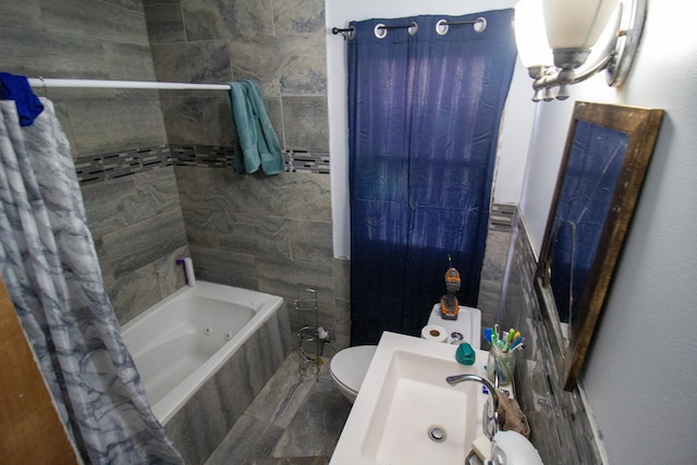 full bathroom with toilet, shower / tub combo with curtain, tile walls, and sink