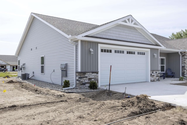 view of front of house with central AC unit and a garage